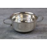 George V silver quaiche of plain form with monogram to centre, scroll handles, makers Adie