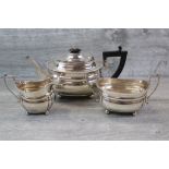 Harrods George V three piece silver tea service comprising teapot, milk jug and twin handled sugar