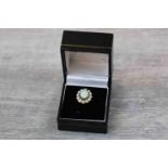 Opal 9ct yellow gold cluster ring, the central oval cabochon cut precious white opal displaying