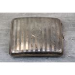 George V silver cigarette case, incised band decoation, initialled central circular cartouche,