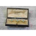 Set of three Edwardian chrysoprase 15ct yellow gold dress studs, the pale green conical cabochon cut