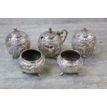 White metal cruet set comprising a pair of matching pepper pots, a pair of open salt cellars and a