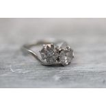 Diamond two stone crossover platinum ring, the two round brilliant cut diamonds each weighing