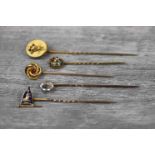 Five Victorian stick pins comprising blue enamelled 9ct gold pennant depicting crowned lion;