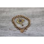 Late Victorian paste set 9ct rose gold brooch, the openwork sinuous form with round purple paste