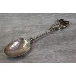 Silver presentation table spoon, the finial formed of a ship held by cherubs, openwork twisted stem,