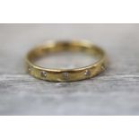 Diamond 18ct yellow gold eternity ring, twelve small round brilliant cut diamonds flush set to band,