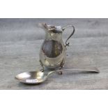 Early George V silver cream jug, baluster form, raised on three feet with shell shoulders,