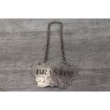 Early Victorian silver decanter label, Brandy, engraved lettering with foliate scroll decoration,