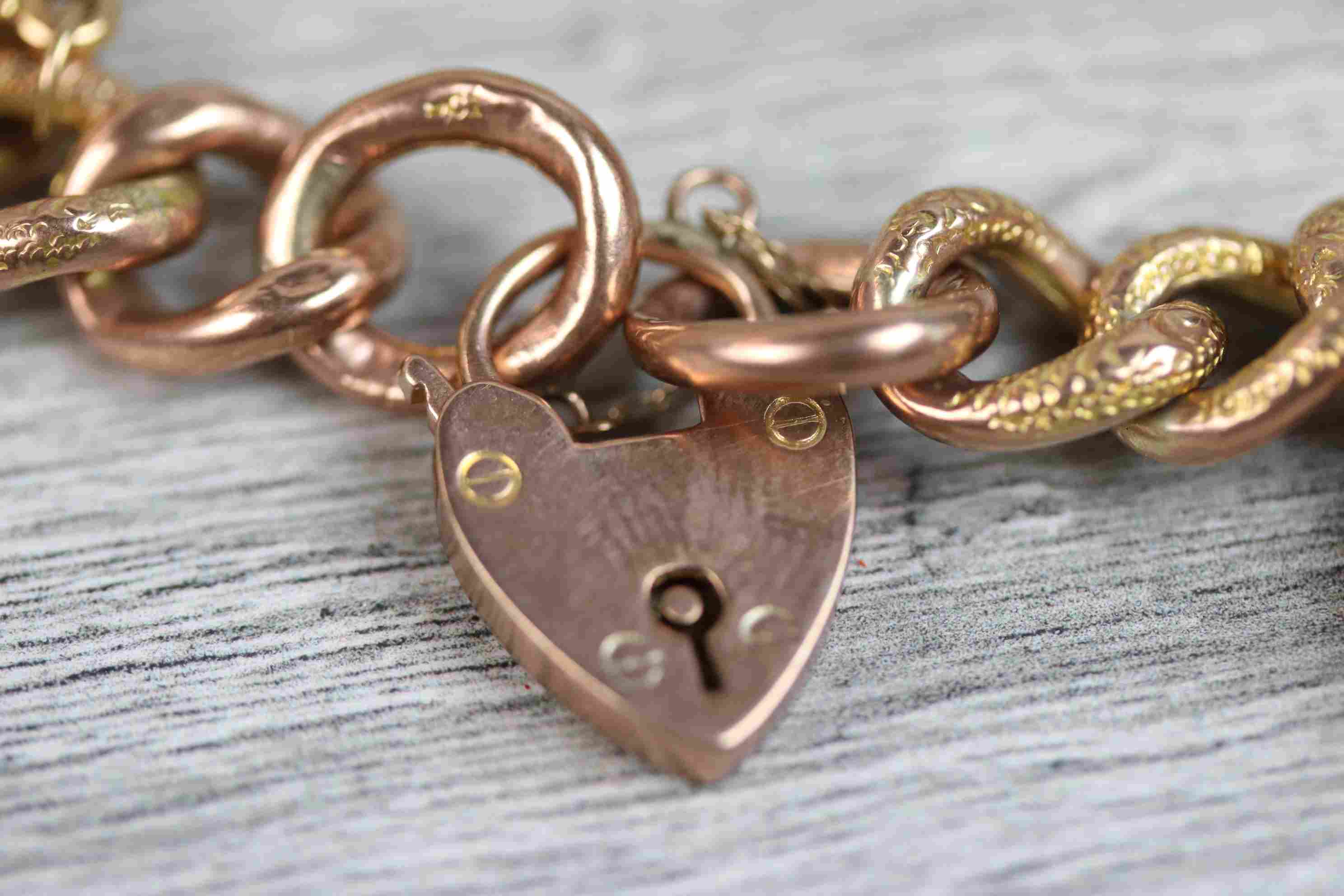 9ct rose gold curb link charm bracelet with 9ct rose gold padlock clasp, seven 9ct gold and yellow - Image 4 of 10