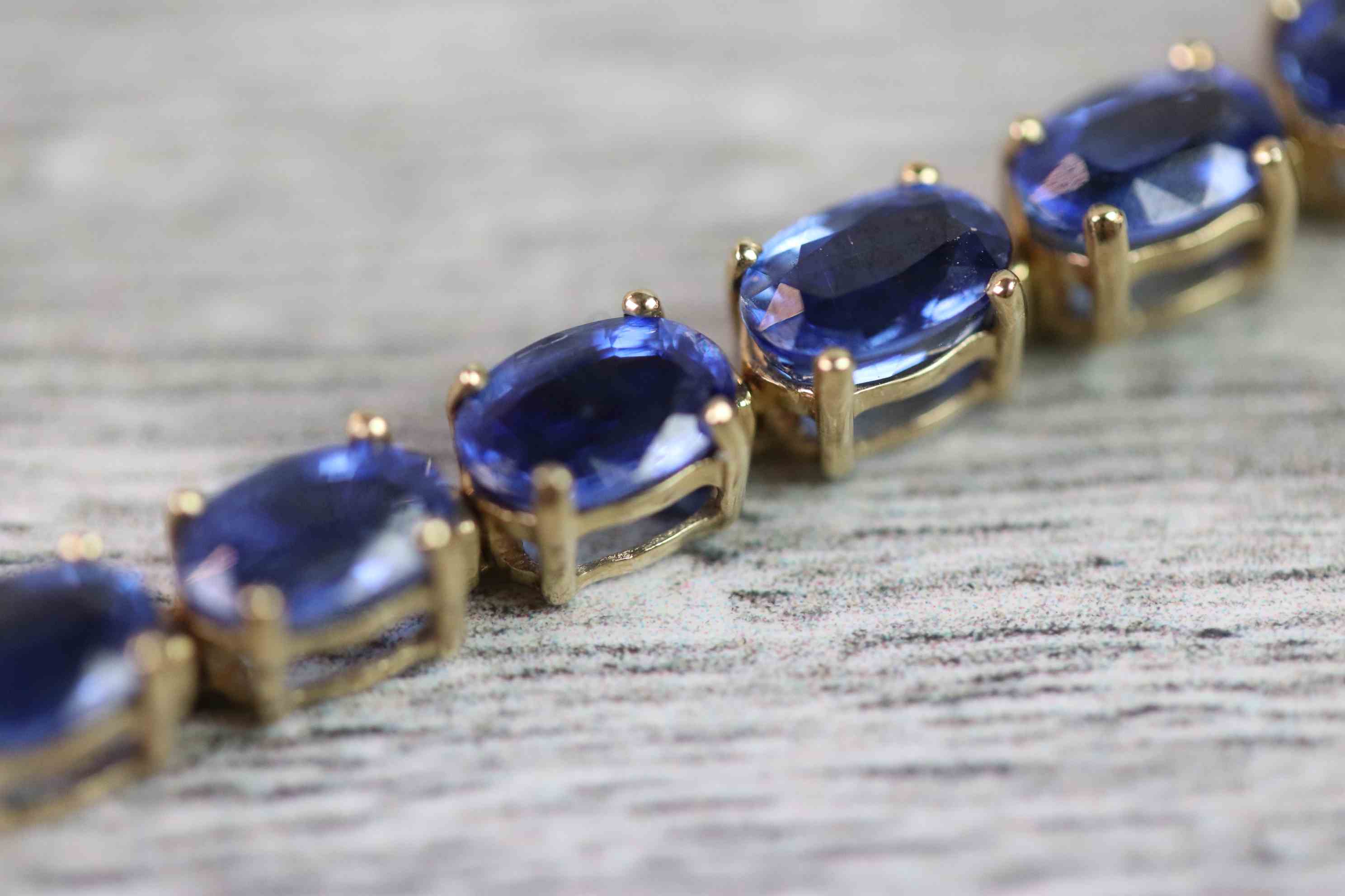 Kyanite 9ct yellow gold line bracelet comprising twenty-eight oval mixed cut kyanite, each kyanite - Image 5 of 8