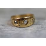 Victorian diamond three stone 18ct yellow gold ring, the central cushion cut diamond weighing