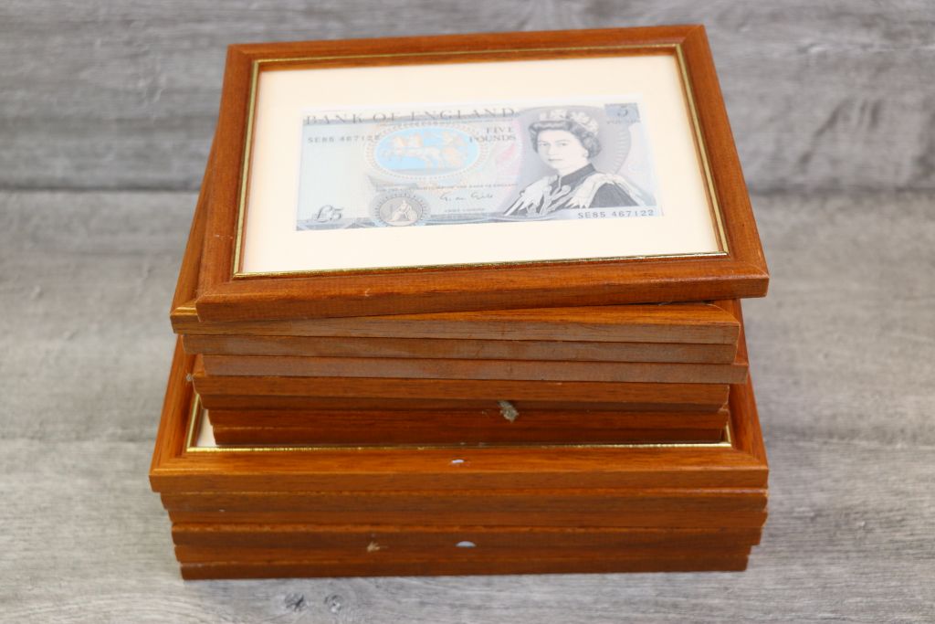 Fifteen framed & glazed vintage UK Banknotes in mostly Uncirculated condition to include;