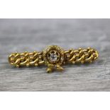 Victorian Etruscan Revival diamond yellow metal bar brooch, the central wreath motif with round