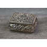 Late Victorian silver snuff box, the hinged lid and body with repousse floral scrolled decoration,