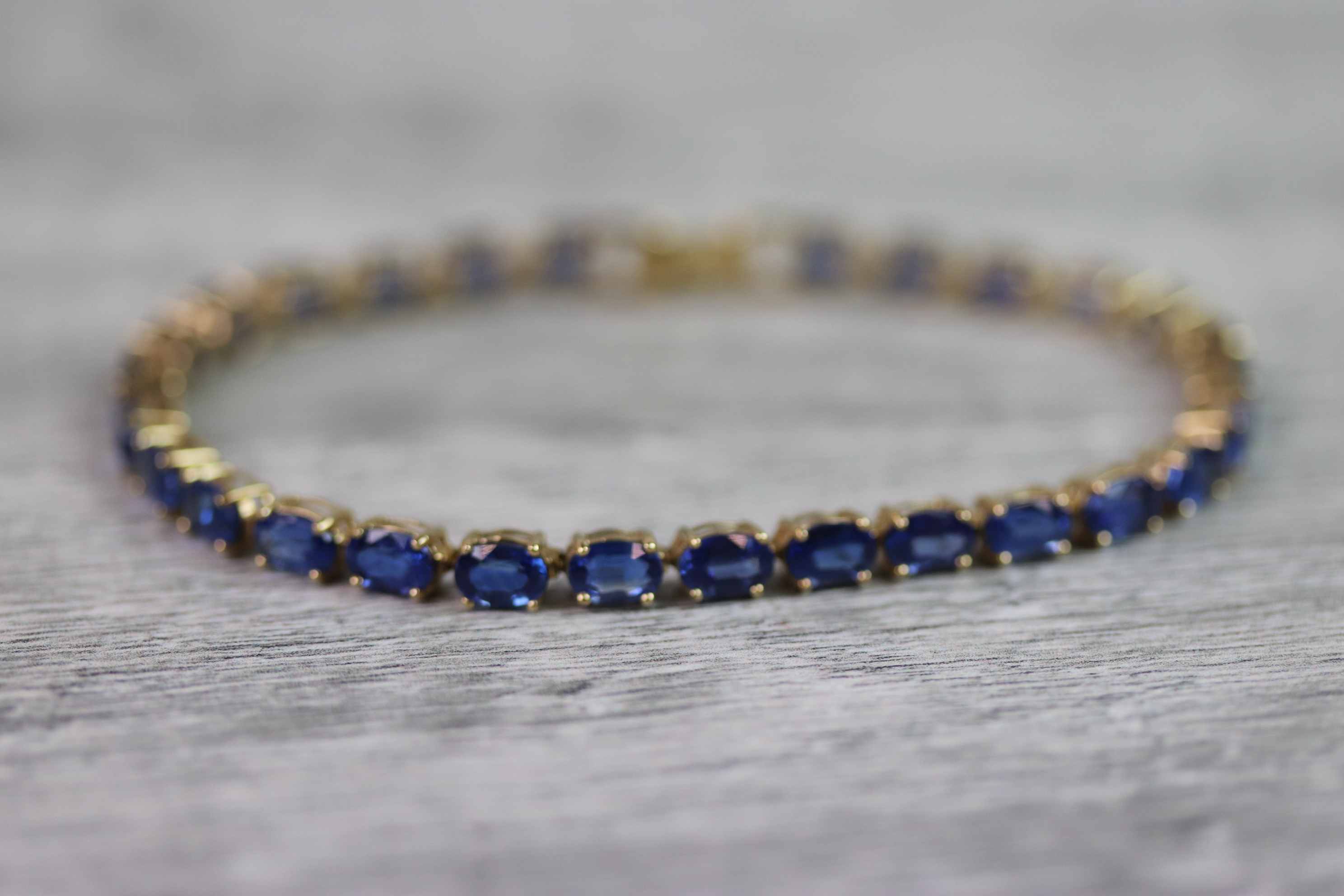 Kyanite 9ct yellow gold line bracelet comprising twenty-eight oval mixed cut kyanite, each kyanite - Image 2 of 8