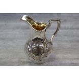 Victorian small silver jug, chased and repousse foliate decoration to body, one cartouche