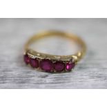 Victorian ruby five stone 18ct yellow gold ring, five graduated cushion cut rubies, the largest