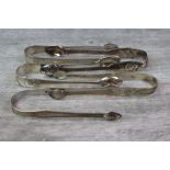 Five silver sugar tongs to include an early Victorian pair, fiddle and thread pattern with shell
