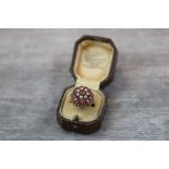Ruby and pearl 14 carat yellow gold three tier cluster ring, the centre small round mixed cut ruby