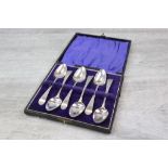 Cased set of six George III silver teaspoons with bright cut decoration and initialled terminals,