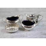 Pair of late Victorian twin handled silver boat shaped salts with later blue glass liners,