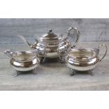 George V three piece silver tea service comprising teapot, sugar bowl and milk jug, of rounded