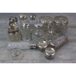 Collection of silver topped cut glass dressing table jars and scent bottles to include three