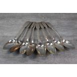 Eight Victorian silver dessert spoons, fiddle pattern, initialled terminals, makers Robert Williams,