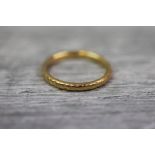 22ct yellow gold wedding band with engraved floral decoration, band width approximately 2mm