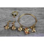 18ct yellow gold Christening charm bracelet with three charms to include Snoopy, a pair of