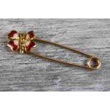 Enamelled 18ct yellow gold brooch in the form of a butterfly, red and white enamel on safety pin