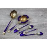 Marius Hammer: four Norwegian enamelled silver gilt coffee spoons, with matching tea strainer and