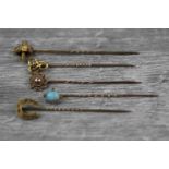 Five Victorian and Edwardian stick pins to include precious white opal and seed pearl rose metal