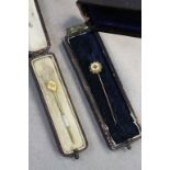 Two boxed 9ct Gold Stick Pins, both set with small Diamonds