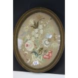 19th century Oval Embroidery on Silk of Floral Display contained in a Gilt Frame, 40cms high
