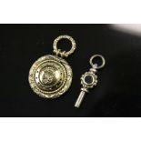 Stone set Yellow metal Pocket watch key and a Yellow metal locket on swivel hanger