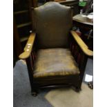 Arts & Crafts period oak slatted side arm chair, with a brown leatherette upholstery on castors