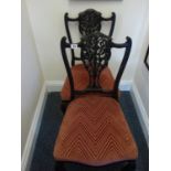 Pair of Art Nouveau style parlour chairs with decorative backs, upholstered in a Salmon coloured