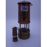 Brass and copper Miners Lamp makers mark Ashington, and a miniature version, 3" tall Dartfield