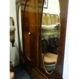 Edwardian period triple compactum wardrobe, mahogany comprising 2 oval mirrored doors one has been