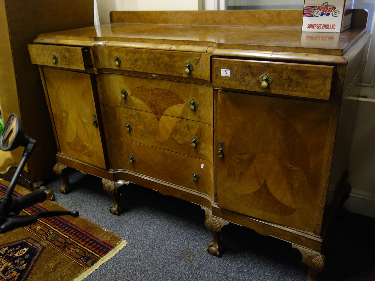 Good quality walnut inverted serpentine shaped sideboard with 4 ball and claw feet to the front, the