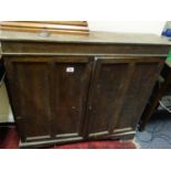 Freestanding Edwardian oak shelving unit with twin shelves enclosed 2 doors to the front on a shaped