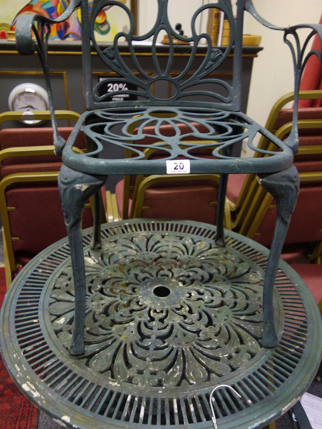 Exterior circular green metal garden table and 2 carver chairs, in a used condition