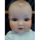 Vintage Doll with glass eyes and baby teeth, composite body, probably original clothing impressed