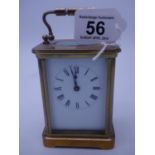 Early 20th century brass 8 day carriage clock, appears to be working, 4" tall 3" dia with key, est