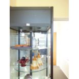 6' 6 tall shops display cabinet with 4 glass circular shelves enclosed highlighted by spot lights, a