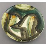 Reginald James LLOYD (British b.1926) ceramic plate decorated in green, black & orange glazes on a