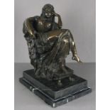 20th Century Bronze Sculpture of a seated nude, draped in fabric, feet raised on a stool mounted