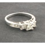 A three stone diamond dress ring, the claw set stones approx 1.3ct total weight, set in 14ct white